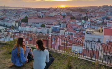 two women seat up the hill and watch their New Community