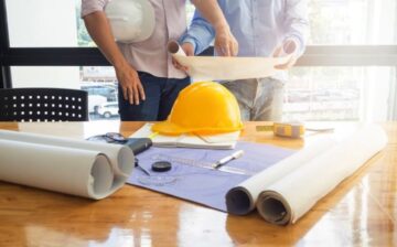 men looking at construction plans of a house