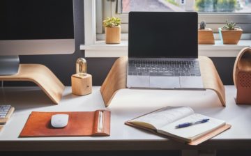home office with laptop, desktop and a table
