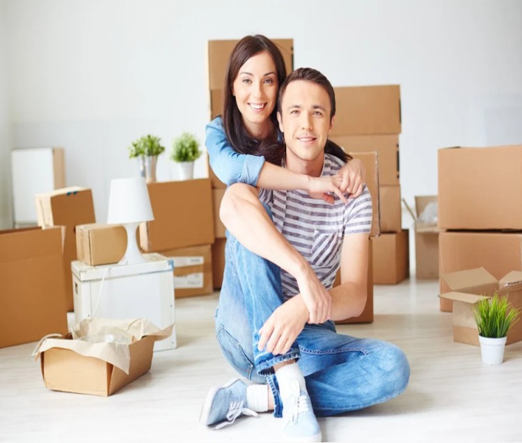 couple moving with packed boxes around