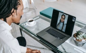 a man speakes to a woman using a laptop