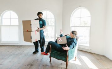 two movers moving packed boxes