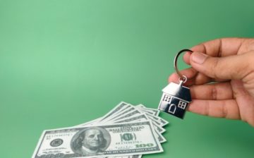 dollar bills and a house key chain