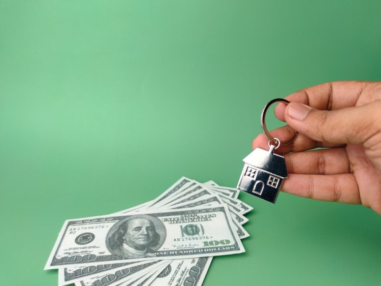 dollar bills and a house key chain