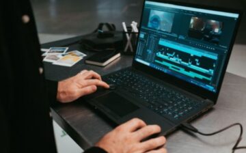 a man types on his laptop