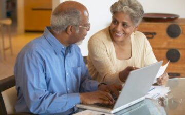 a retired couple with lap top
