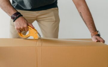 a man packs a moving box