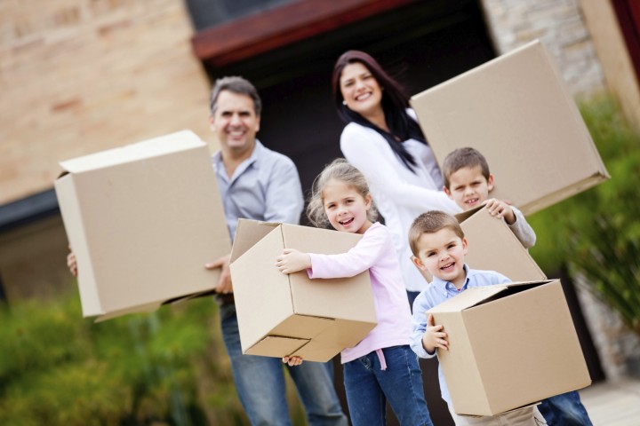 a family is holding moving boxes