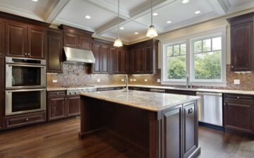 remodeled kitchen with island many cabinets in wood color