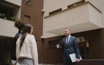 Female couples with real estate salesman