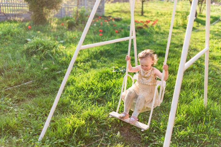 charming little girl laughs playing field 
