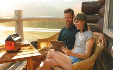 couple charging ipad with electricity generator