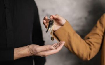 woman handing over house key