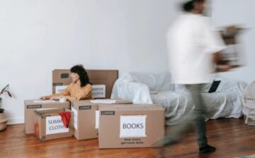 a couple is moving packed boxes