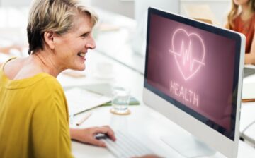 health heartbeat icon on a desk top watched by a nurse