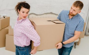 man woman carrying big box