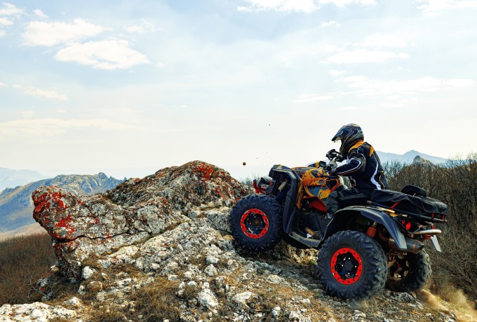 man helmet sitting on ATV