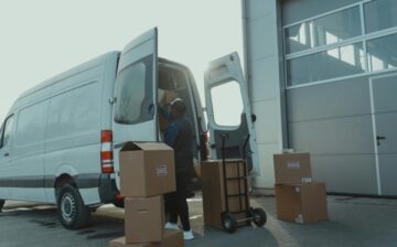van with a man and boxes moving into storage